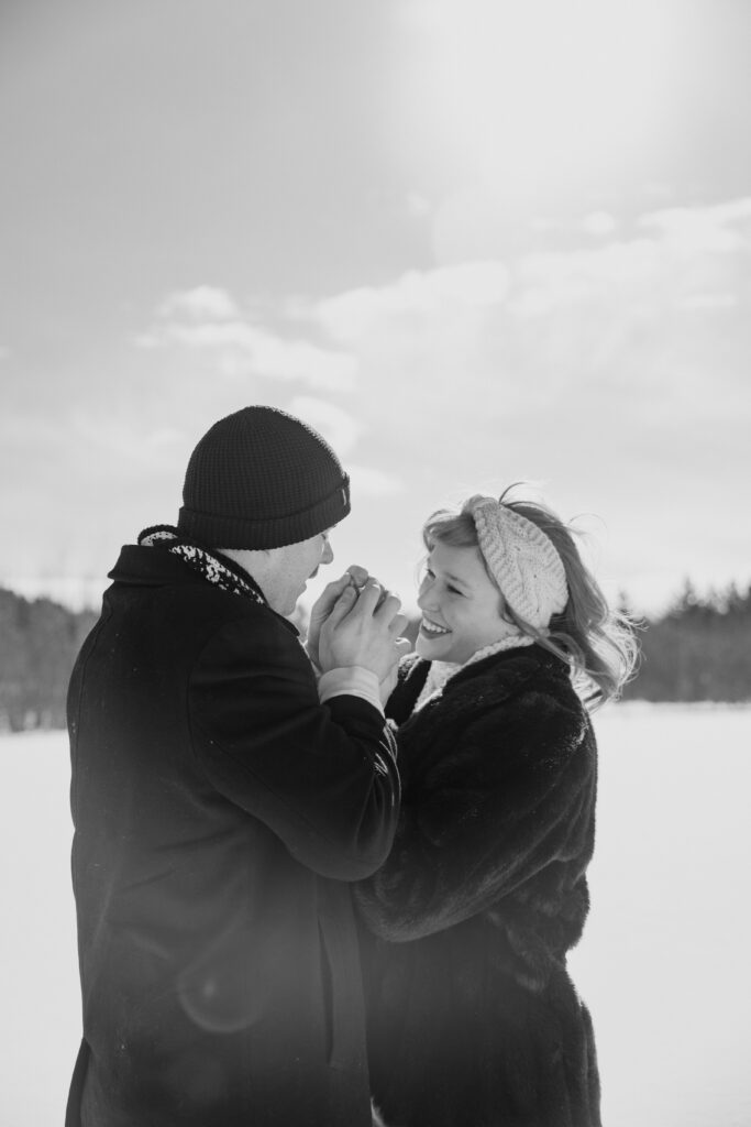 Couple in the snow warming up each other's hands