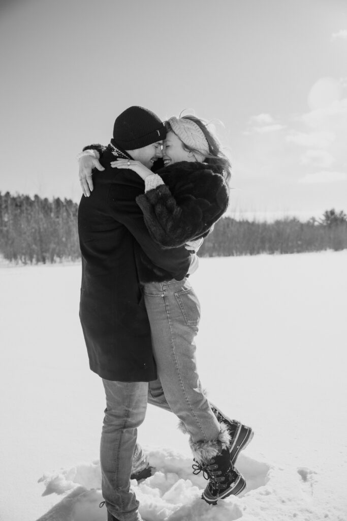 Couple snuggling and kissing in the snow