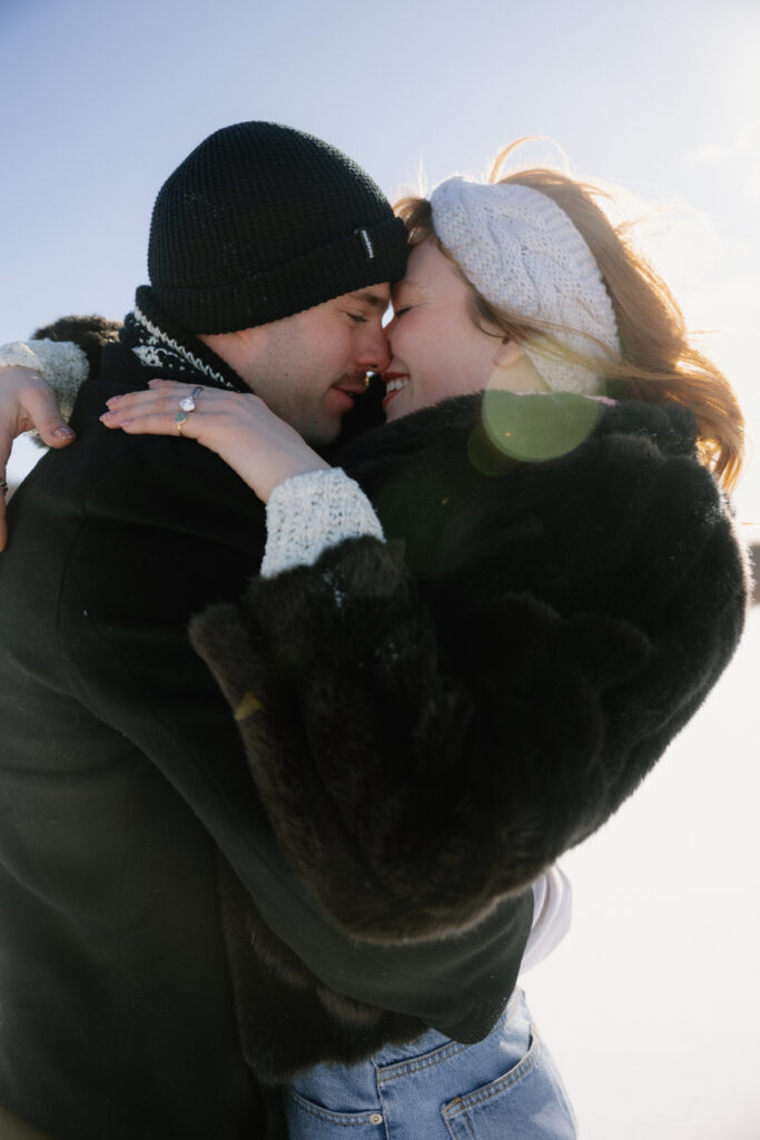 Couple snuggling and kissing in the snow