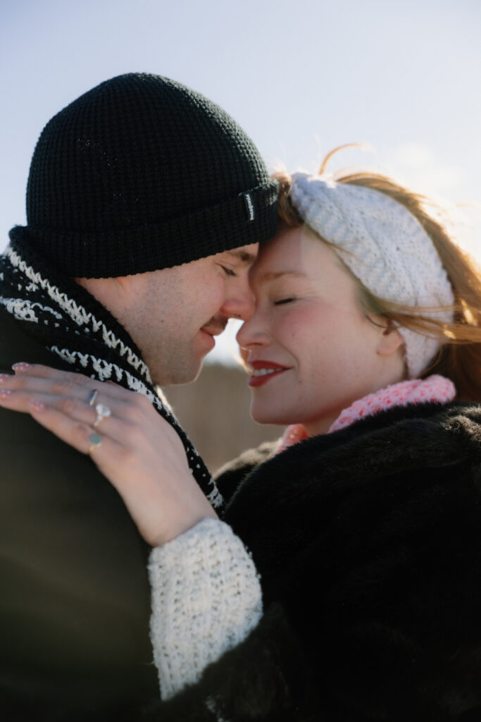 Couple snuggling and kissing in the snow