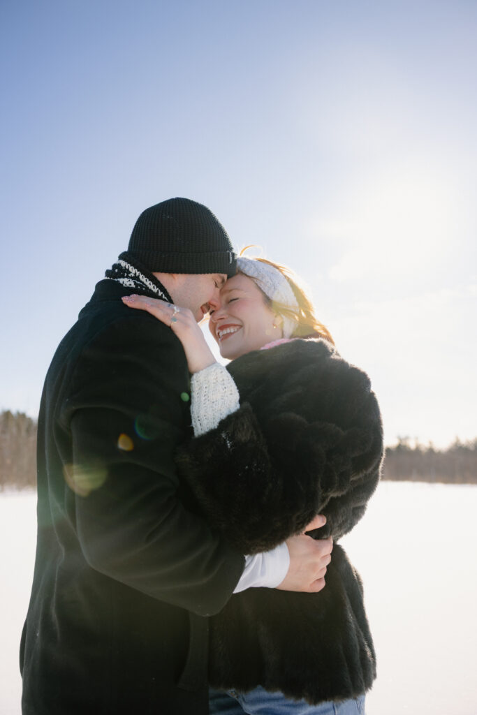 Couple snuggling and kissing in the snow
