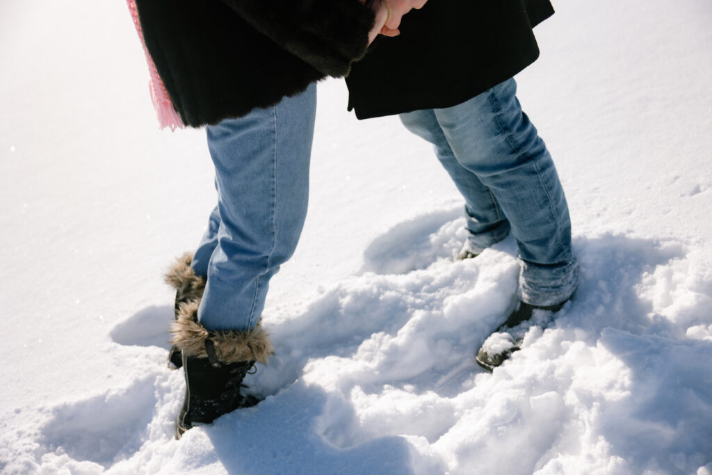 Close up of feet standing in the snow