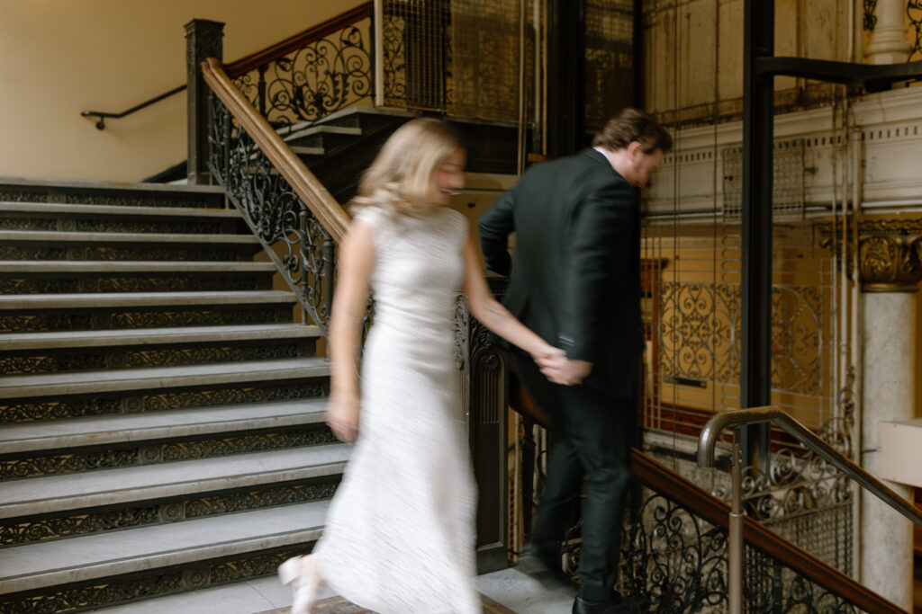 Toronto Old City Hall Civil Ceremony Couple running down stairs blurred