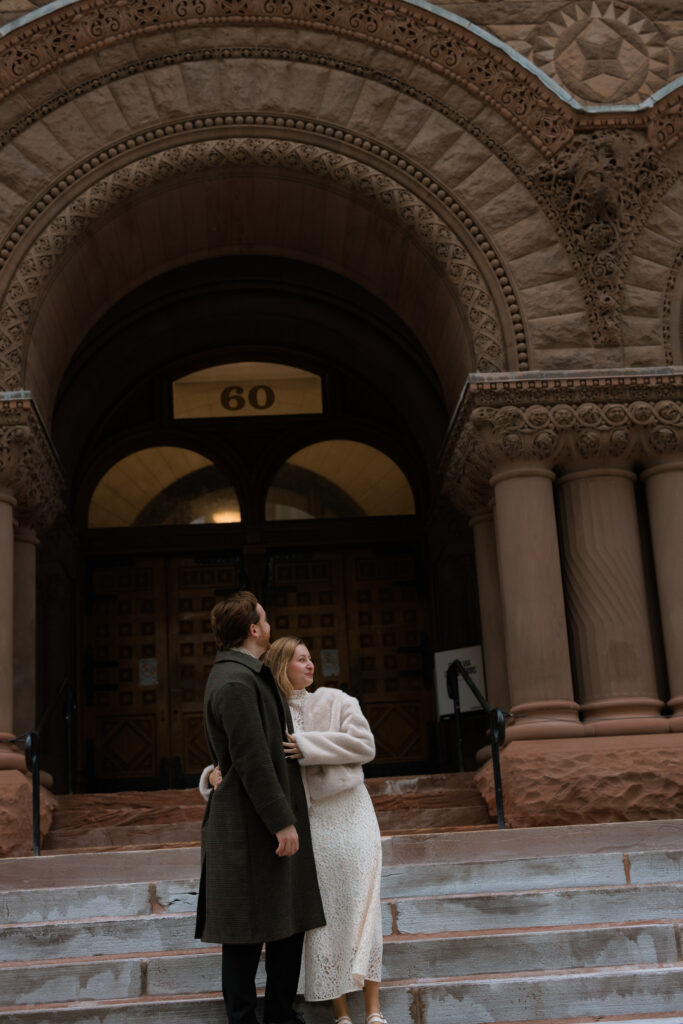Couple standing outside on the steps of Toronto's Old City Hall