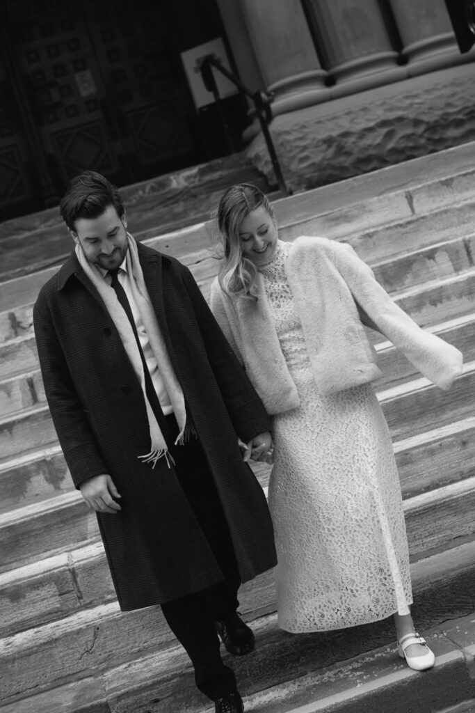 Couple outside walking down the steps of Toronto's Old City Hall