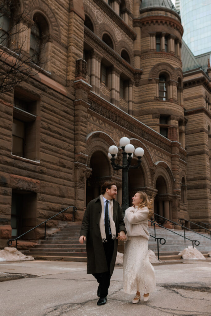 Couple outside of Toronto's Old City Hall running