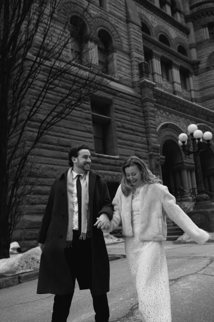 Couple outside of Toronto's Old City Hall running