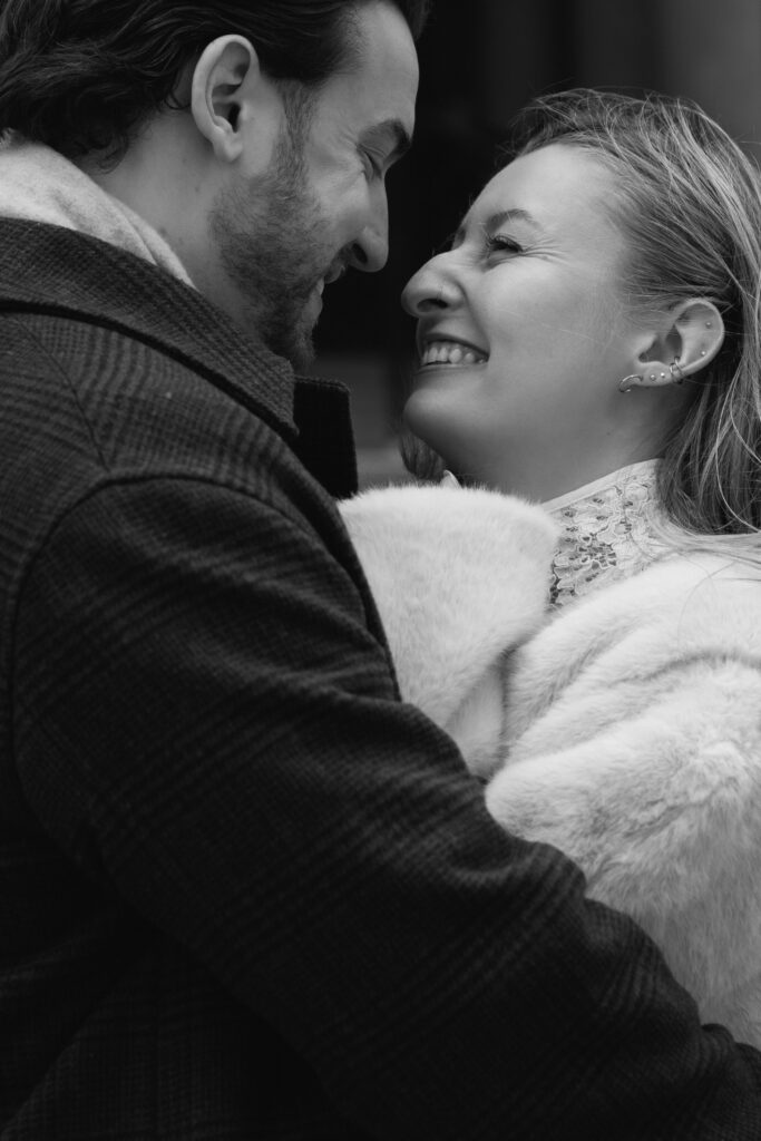 Close up of couple getting cozy about to kiss outside of Toronto's Old City Hall