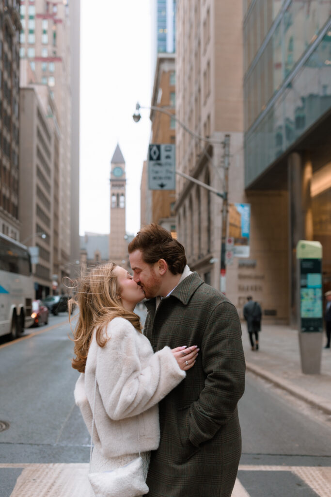 Toronto Couple kissing in the street with Old City Hall in background