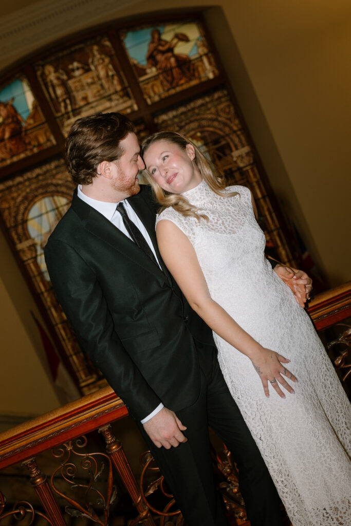 Toronto Old City Hall Civil Ceremony Couple standing infront of stain glass