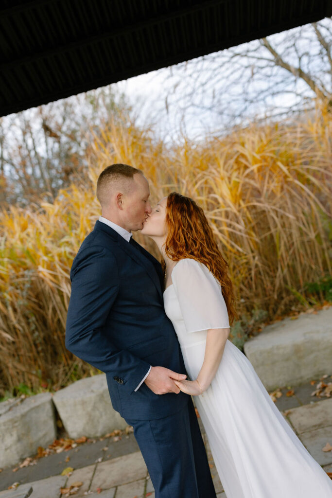Toronto Island proposal couple kissing with tall grass around them