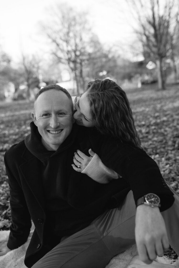 Toronto Island proposal couple kissing from behind