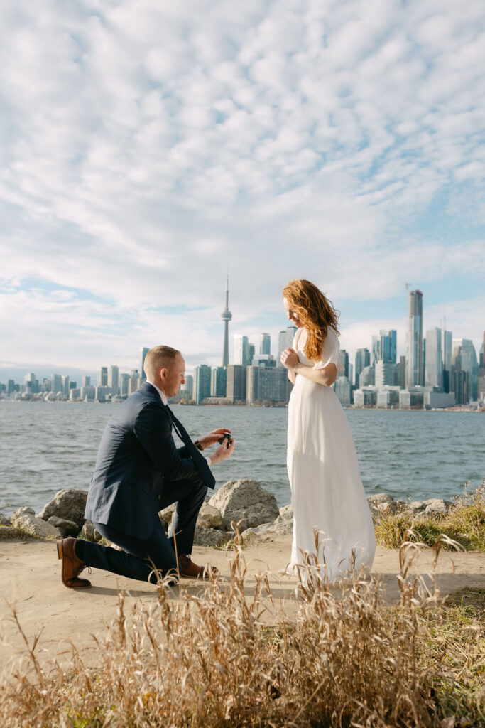 Man kneeling with a ring proposal on the Toronto Island
